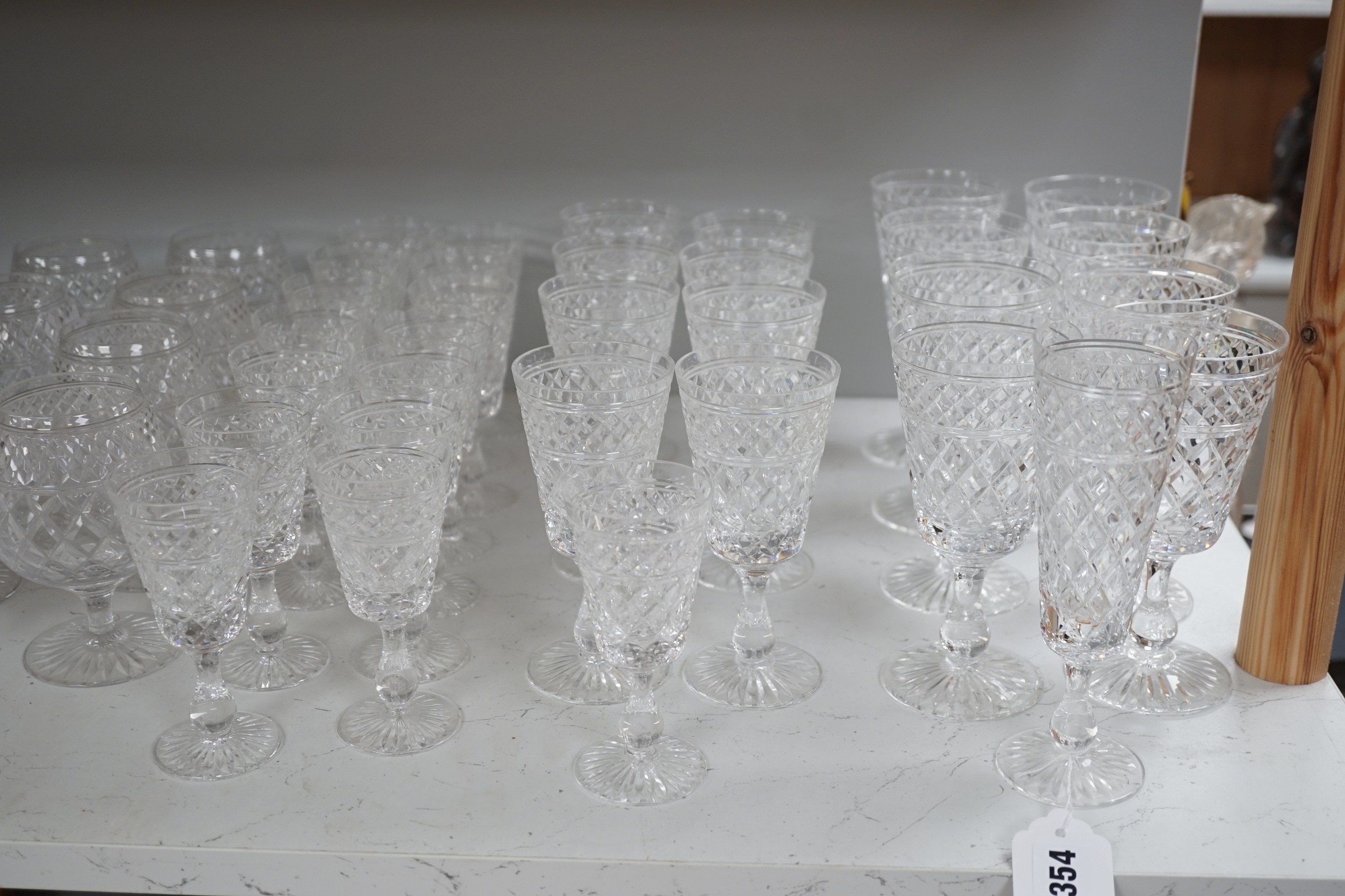 A quantity of Stuart cut glass suite of wine and spirit glasses and a similar pair of decanters